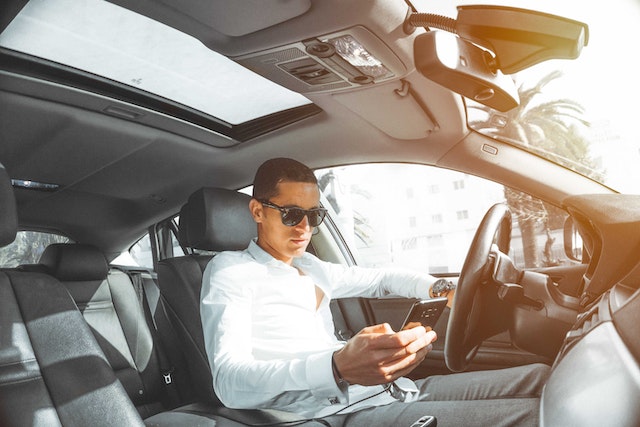 man on phone in car