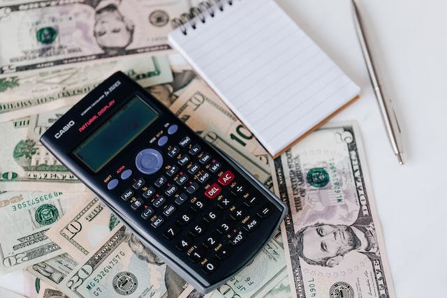 calculator with money and notepad